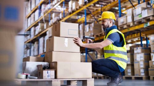 warehouse worker scanning in a case of products