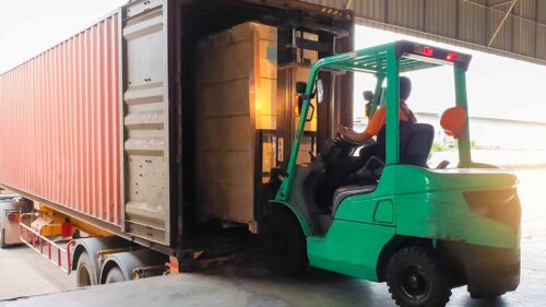 A forklift operator transloading materials